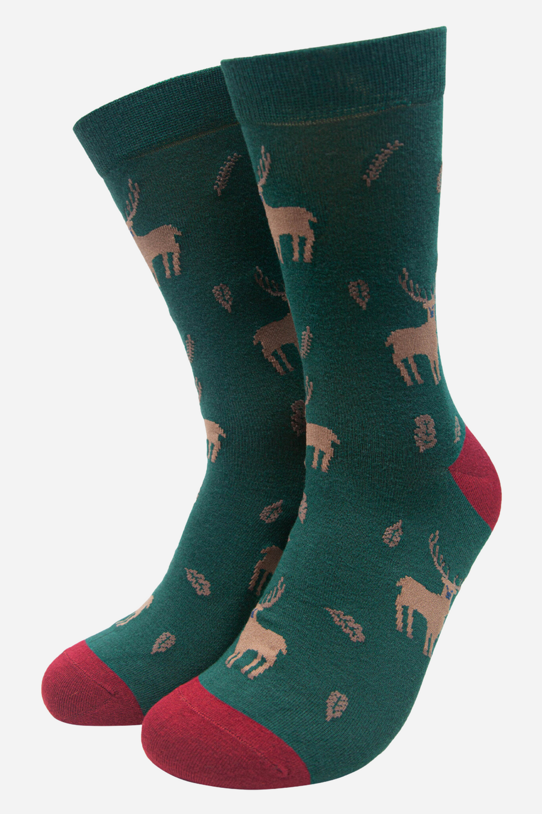 green socks with a beige pattern of stags and autumn leaves, the socks have a red toe and heel