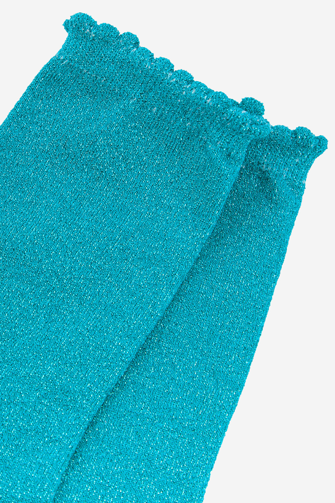 close up of the turquoise sparkly socks and frilly scalloped cuff