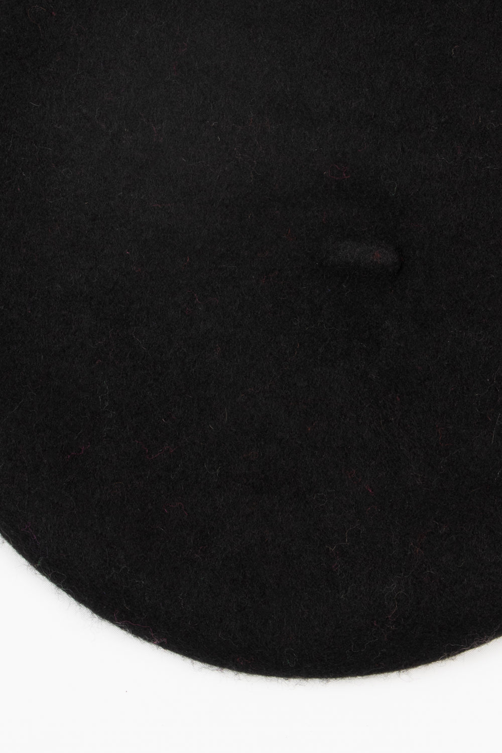 close up of the plain black beret, showing the textured wool blend fabric