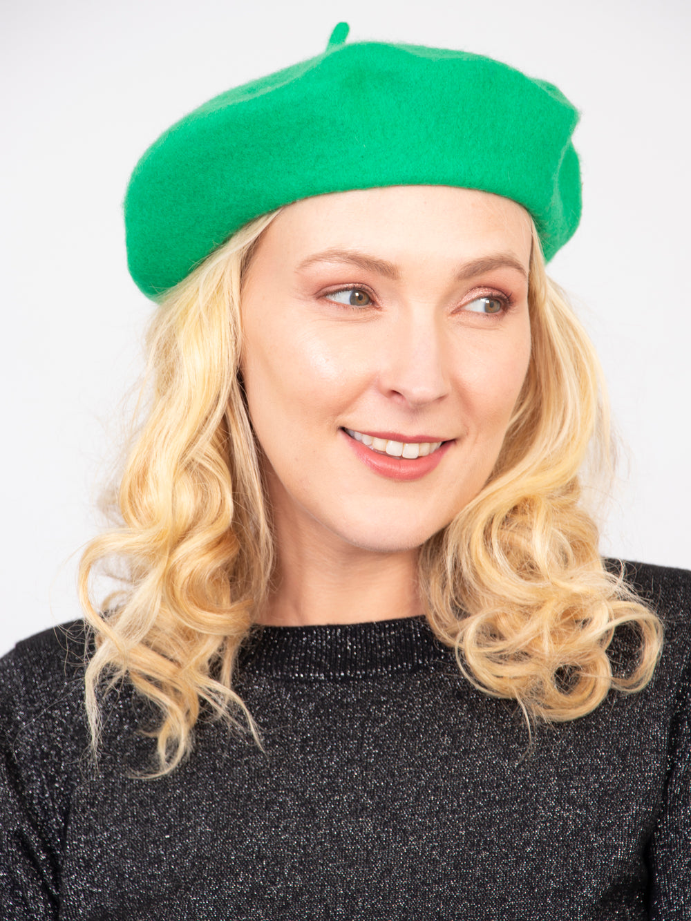 model wearing a bright green plain beret hat