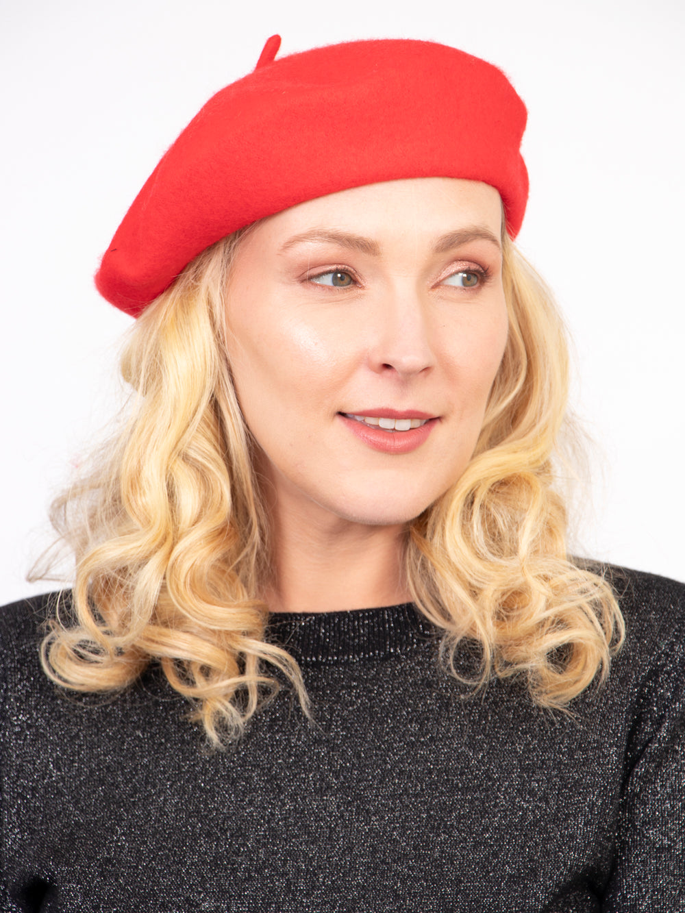 model wearing a bright red plain beret hat