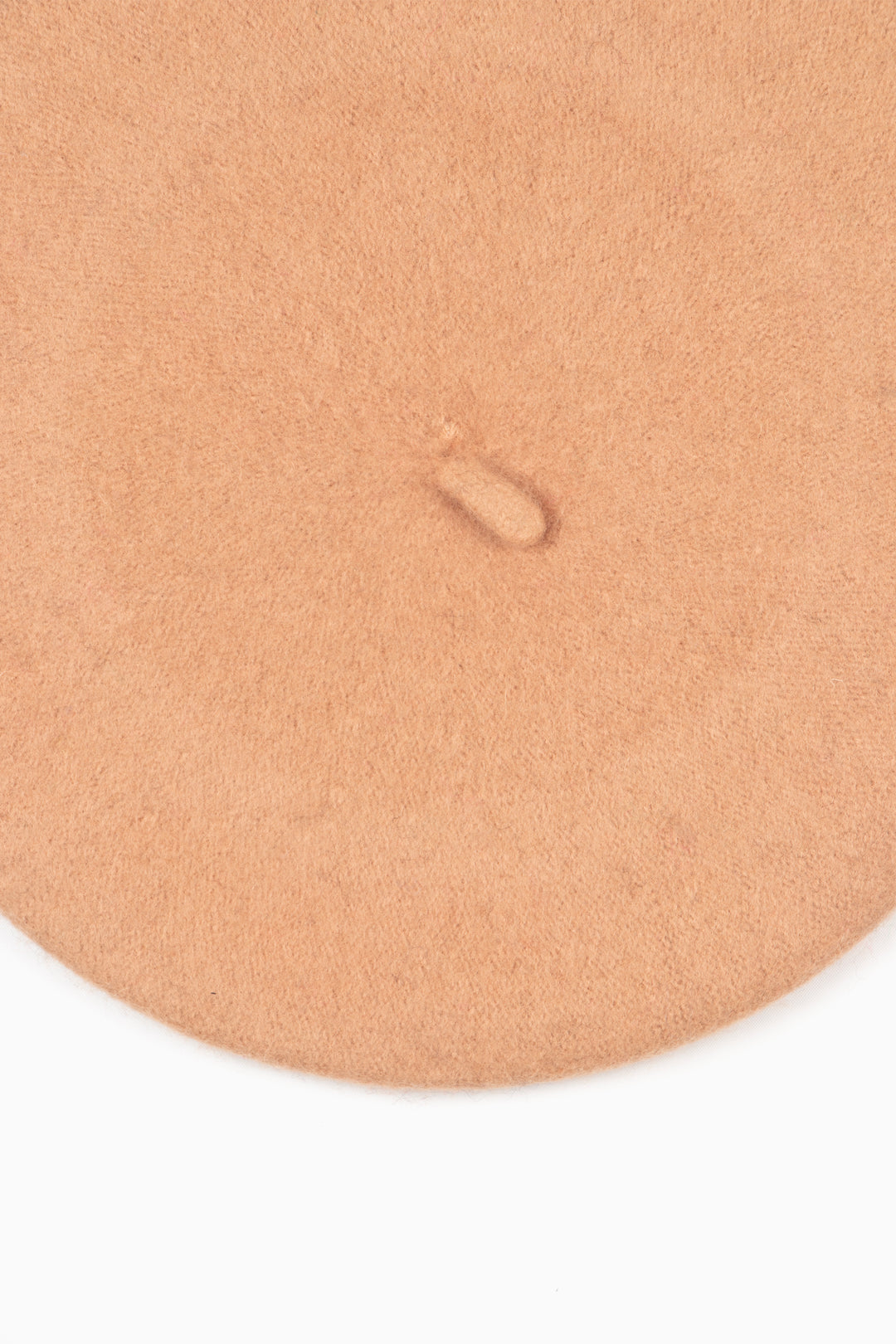 close up of the plain tan beret, showing the textured wool blend fabric