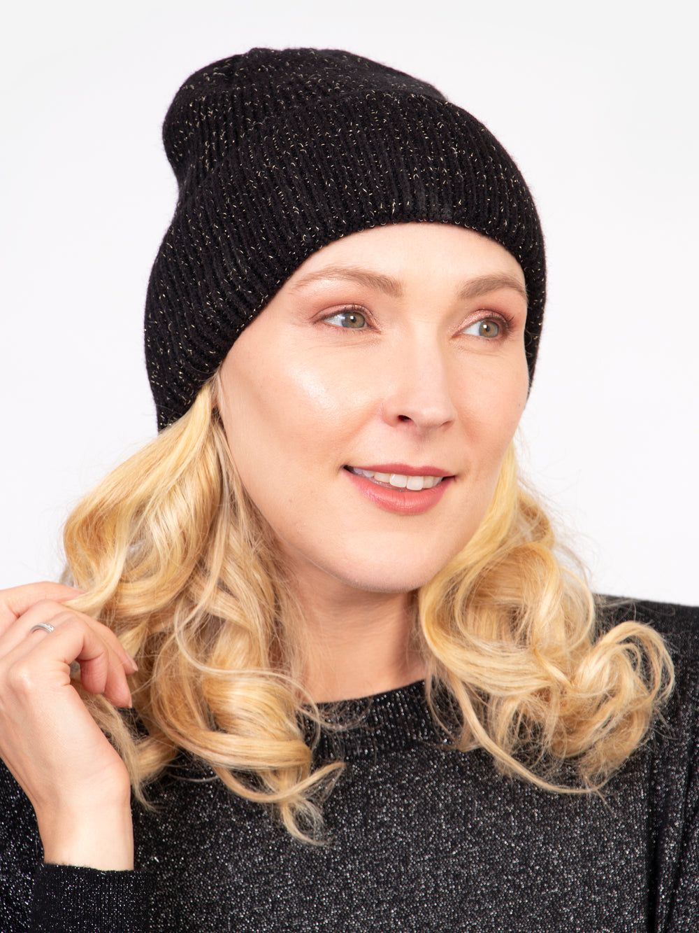 model wearing a ribbed black knitted beanie hat with an all over gold glitter sparkle