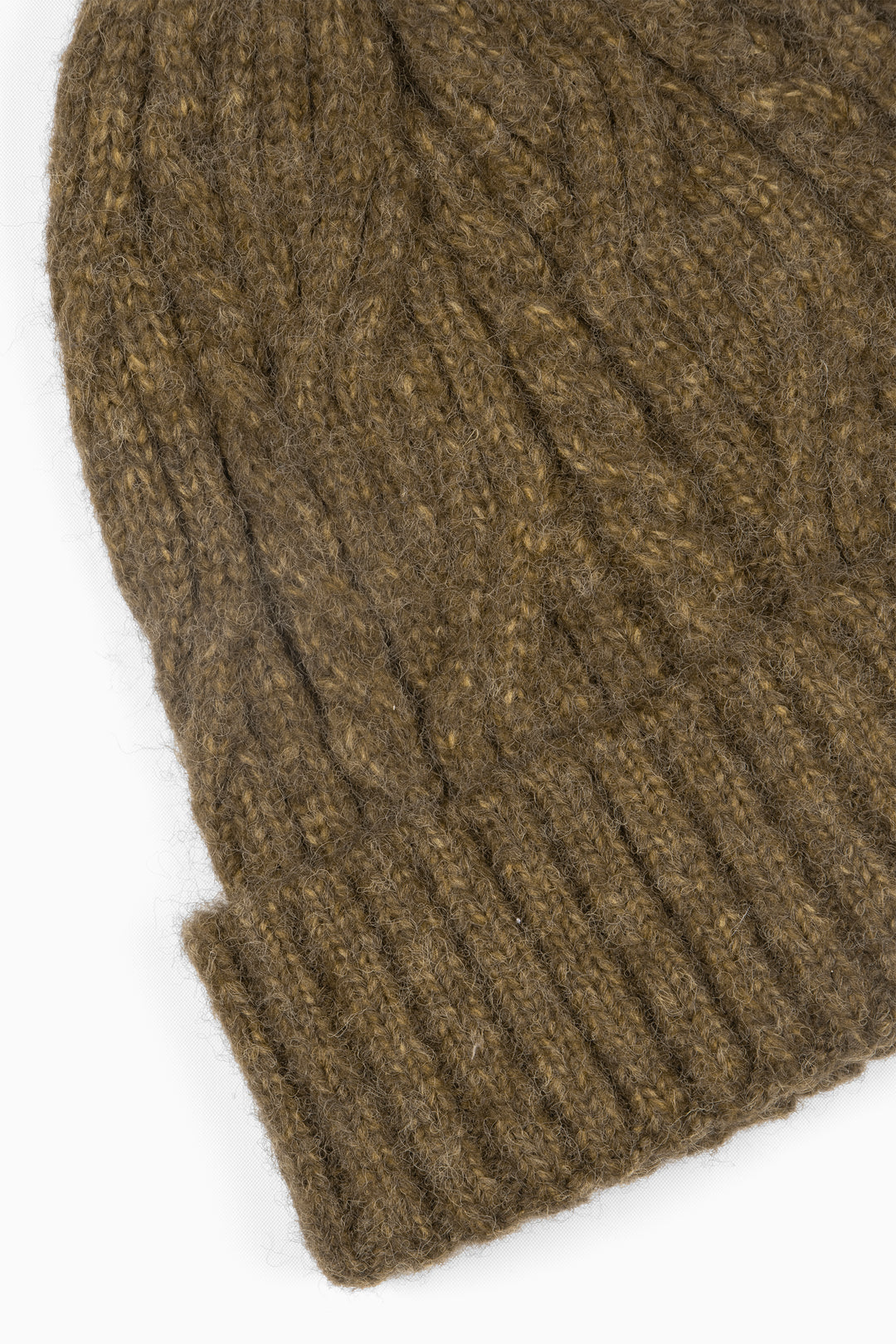 close up of the ribbed brim of the beanie hat and of the cable knit pattern.