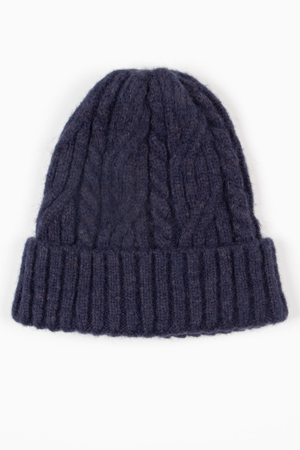 showing the navy blue beanie hat laying flat, the bold cable knit design is shown, the hat also has a ribbed brim.