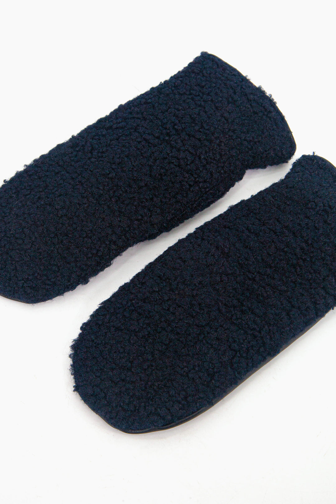showing the mitts laying flat, the navy blue borg fleece is shown to cover the entire back of the gloves.