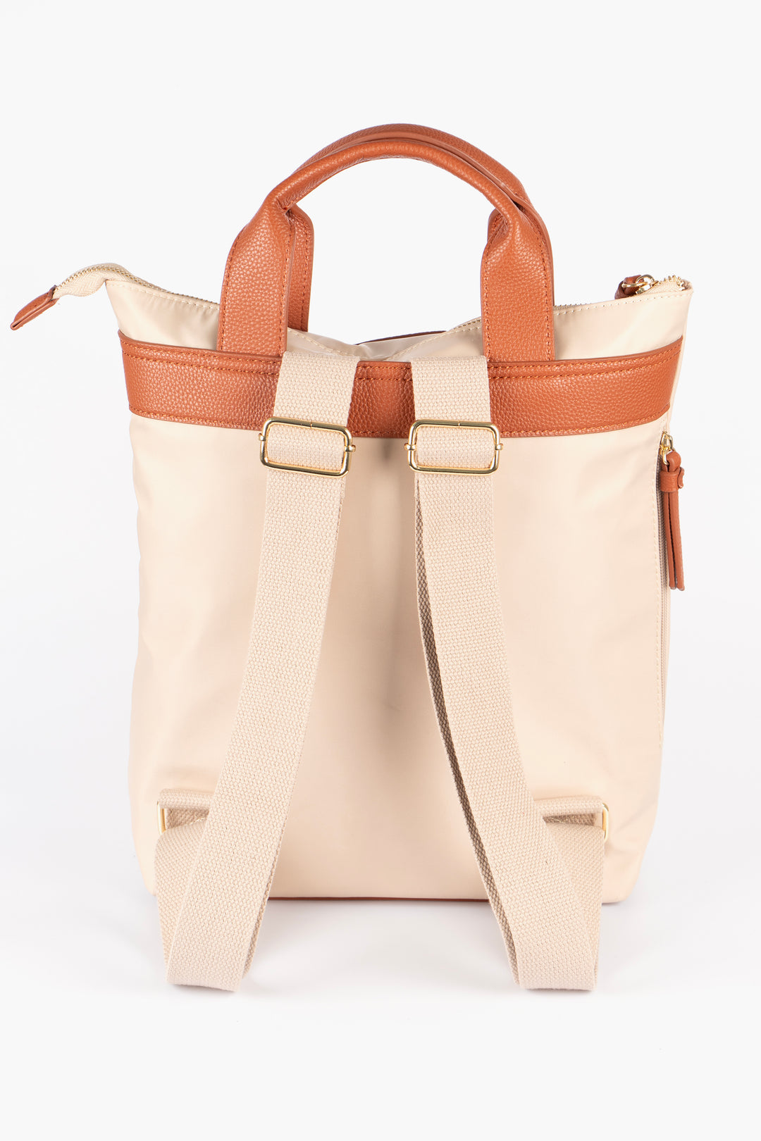 showing the backpack with the straps facing the camera, the straps are also cream and are adjustable. the back pack has to tan faux leather handles on the top.