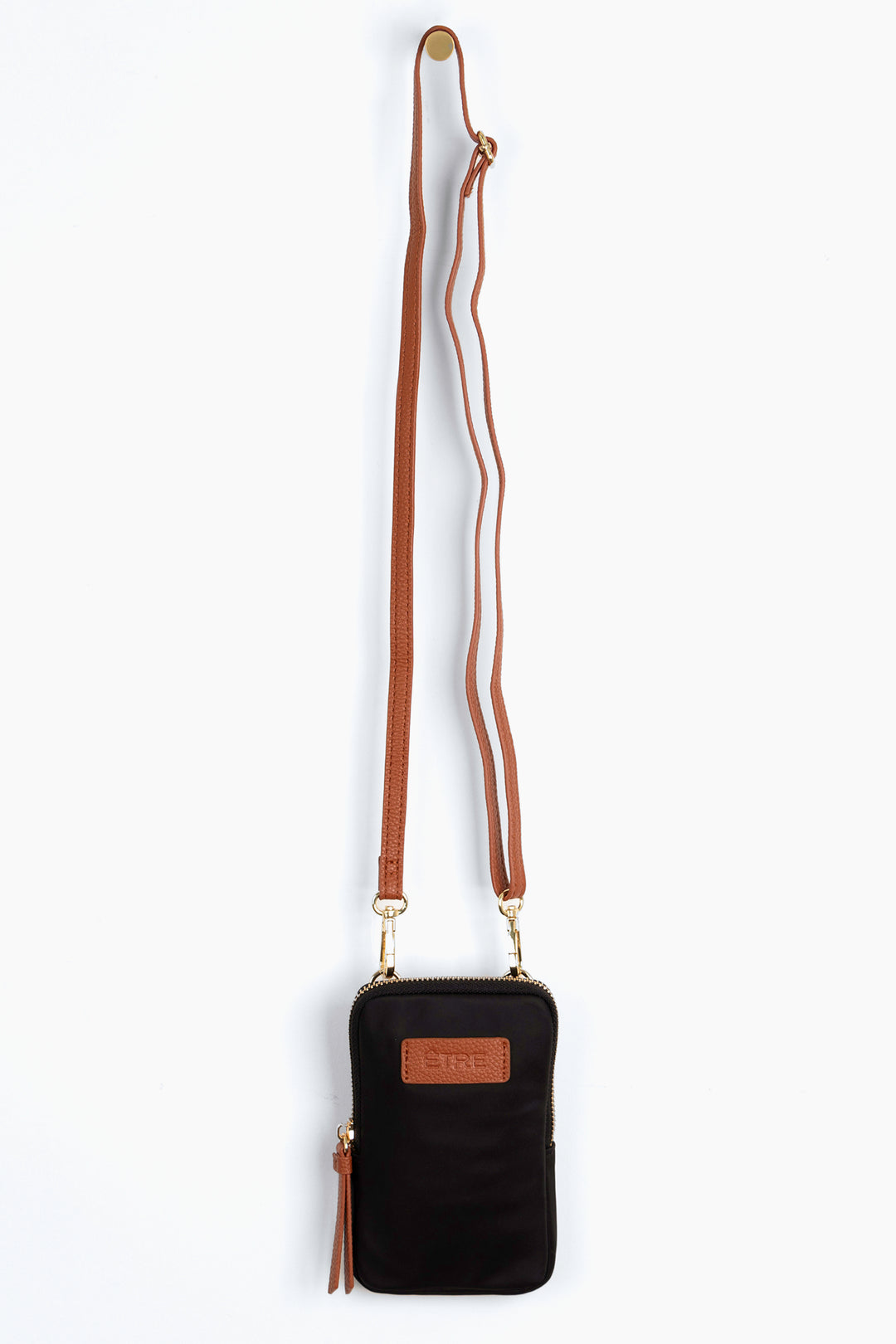 black crossbody phone bag with tan accents and a tan removable adjustable crossbody strap
