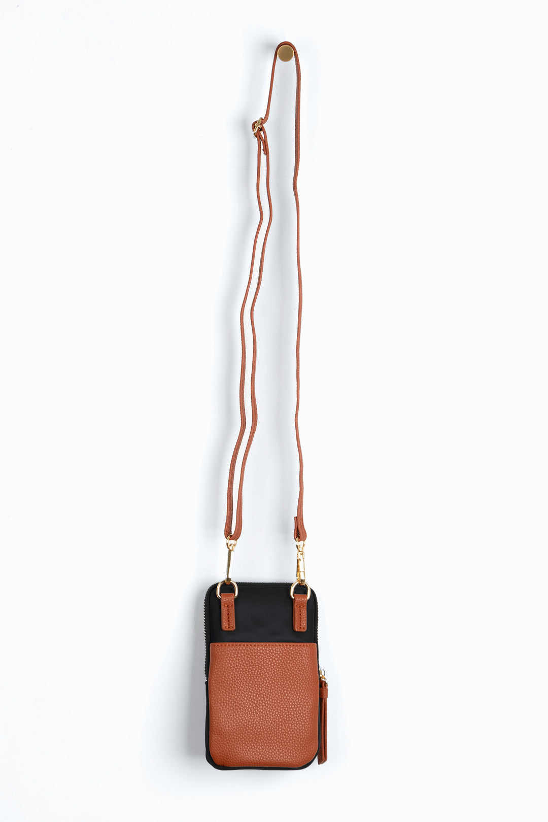 showing the back of the phone bag, there is a tan faux leather external open pocket.