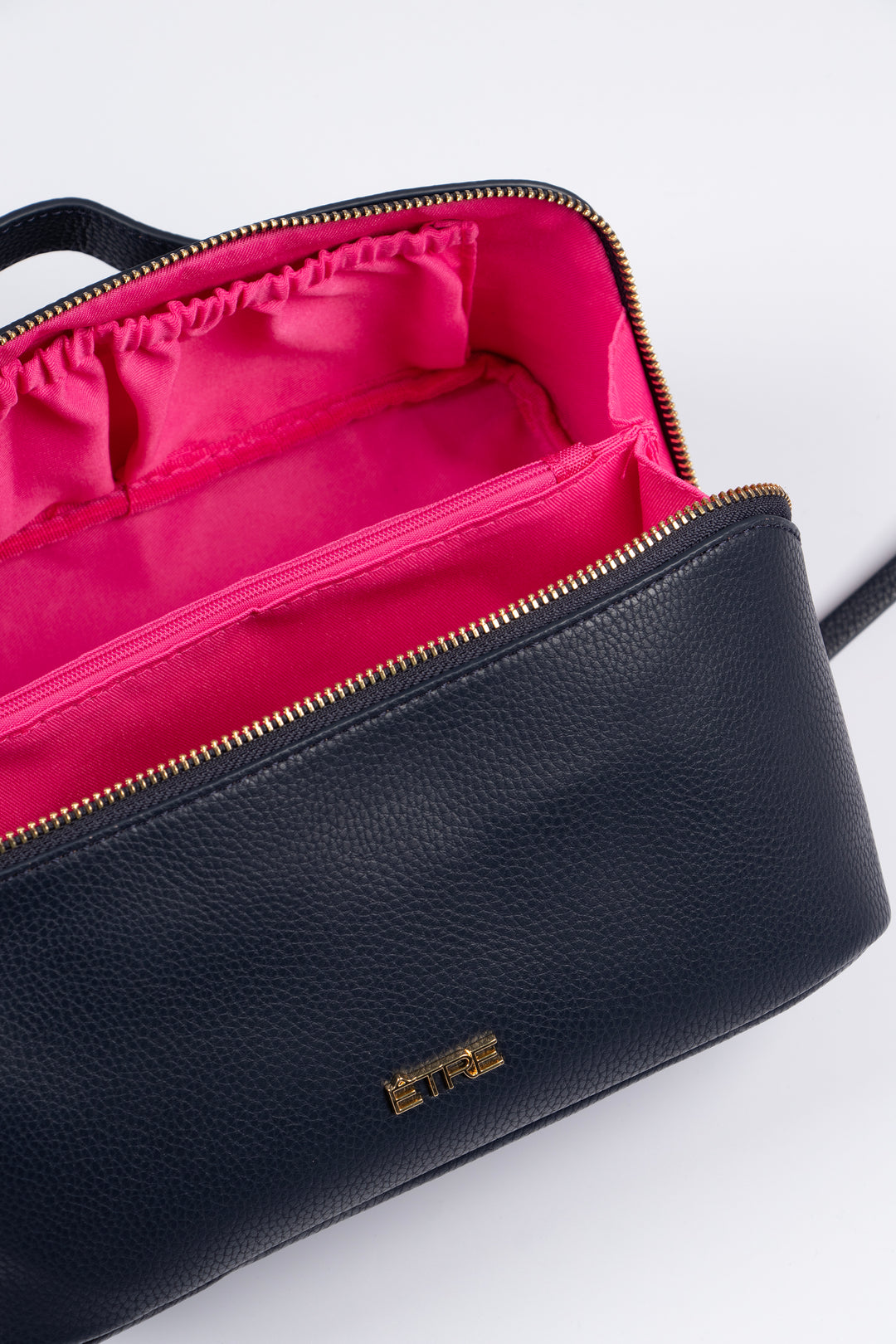 showing the vanity case open, there is a large main storage compartment with open pockets on one side, for storage. There is also an internal zip closure pocket.