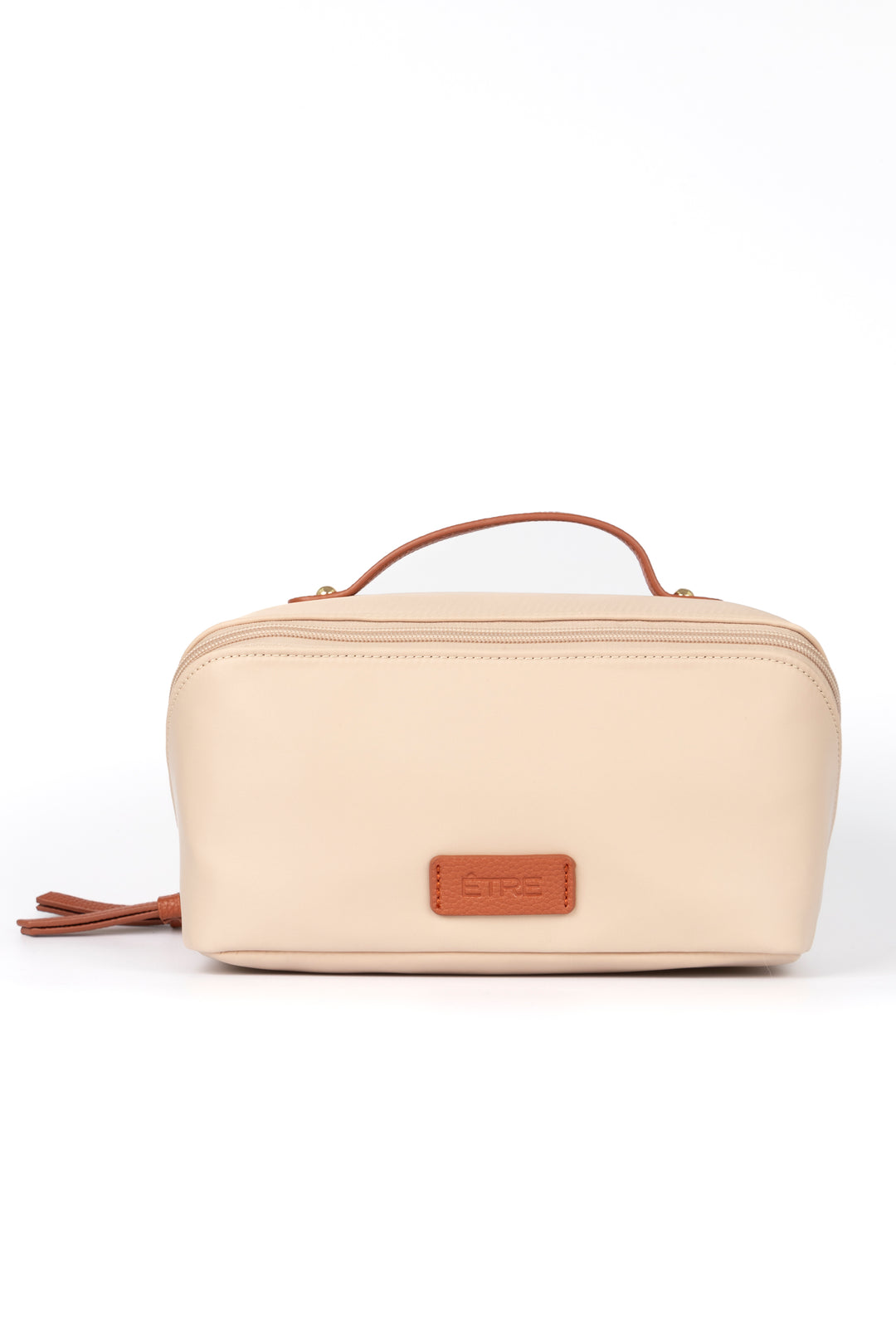 cream vanity case with tan faux leather accents and top handle. the cosmetics bag has zip fastening closure.