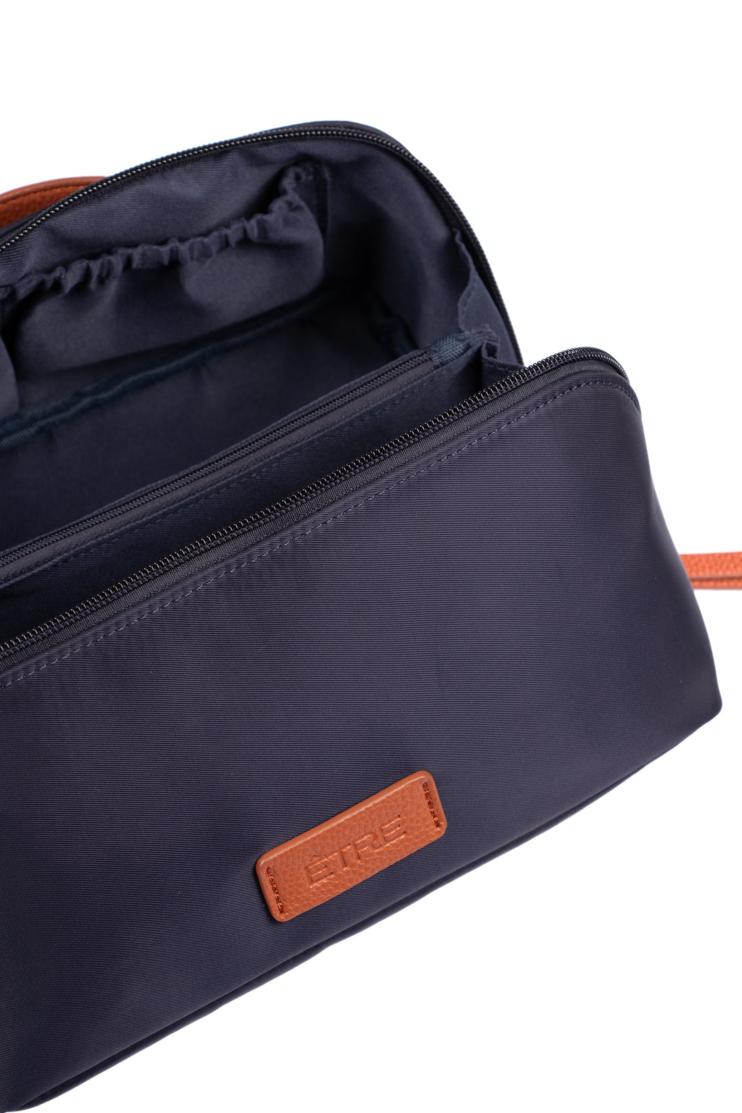 showing the vanity case open, there is a large main storage compartment with open pockets on one side, for storage. There is also an internal zip closure pocket.