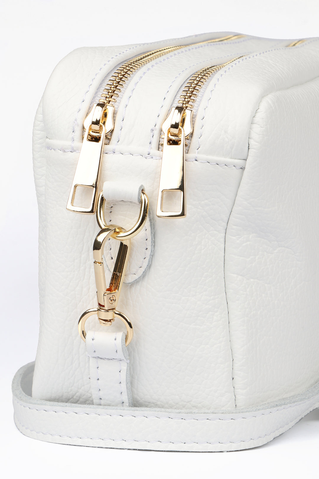 close up of the white genuine italian leather and gold hardware