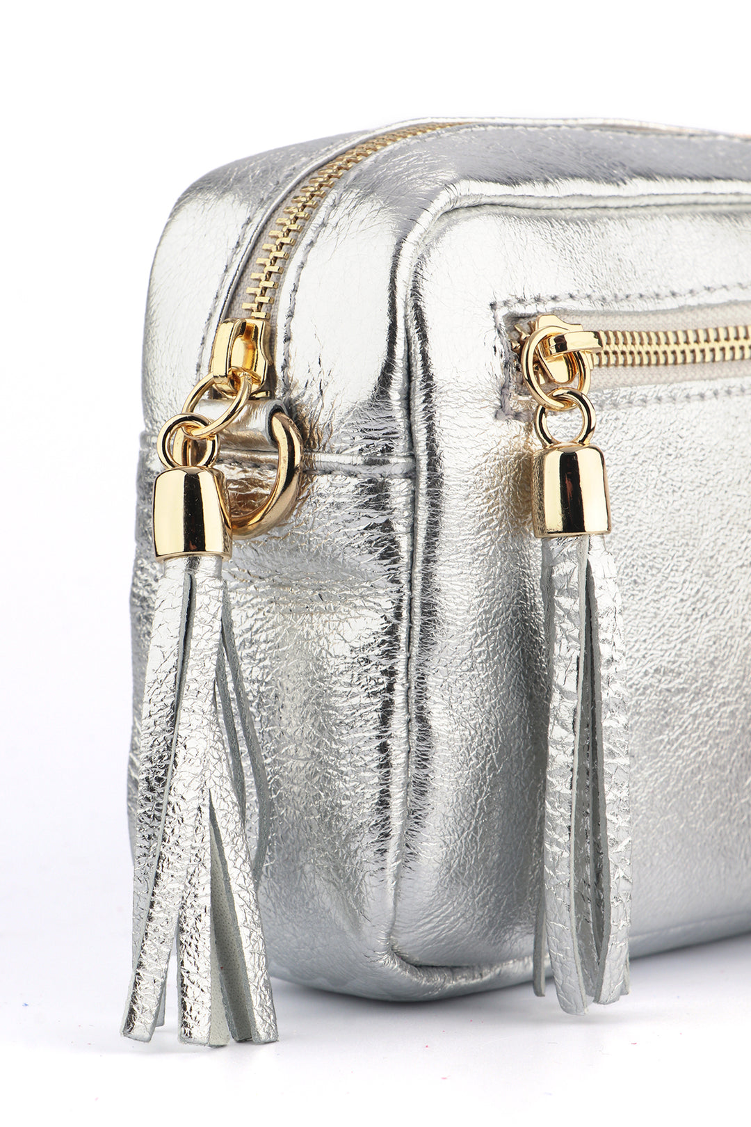 close up of side of the camera bag, showing in close up the metallic silver leather and dual zip closure pockets.
