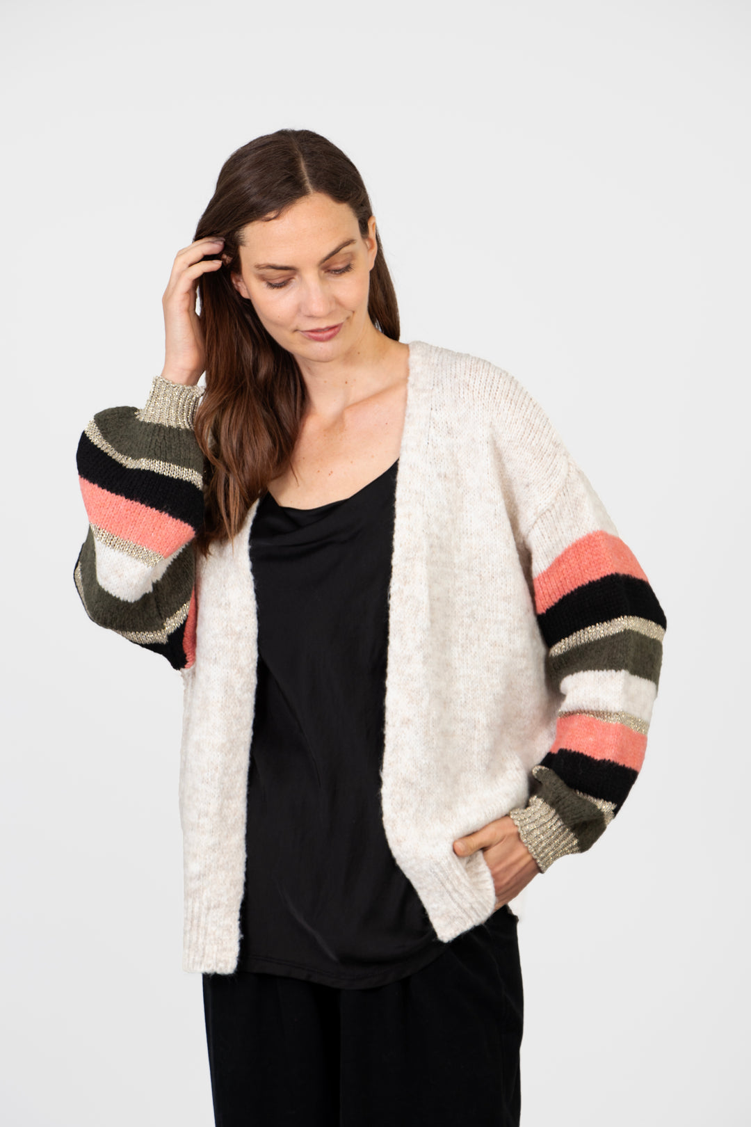 model wearing a relaxed fitting striped balloon sleeve cardigan with an open front