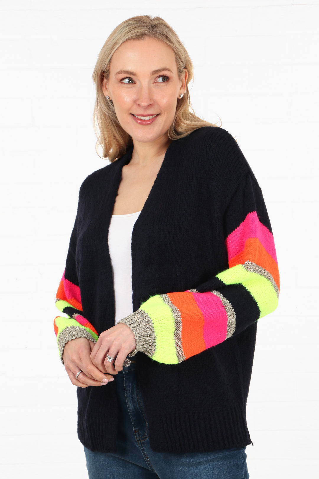 model wearing an open front one size cardigan in navy blue with multicoloured striped long sleeves