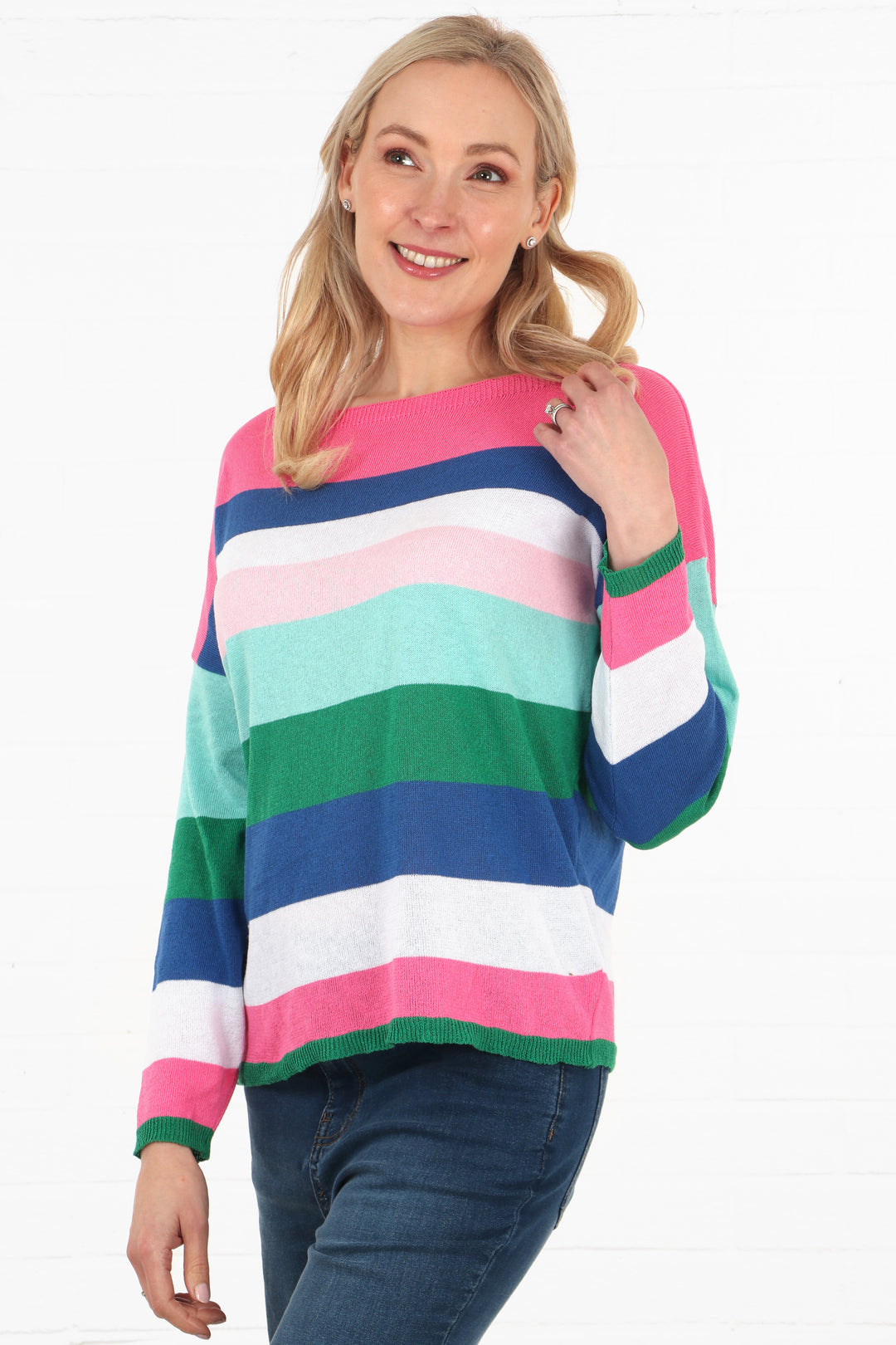 model wearing a pink and multi-coloured stripe long sleeve jumper with slash neck