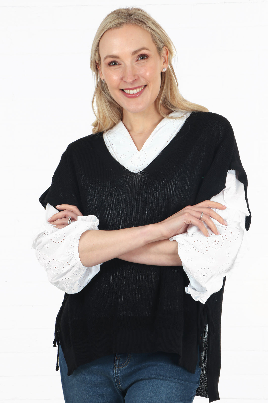 model wearing a black knitted cotton tank top with a v neck and side ties