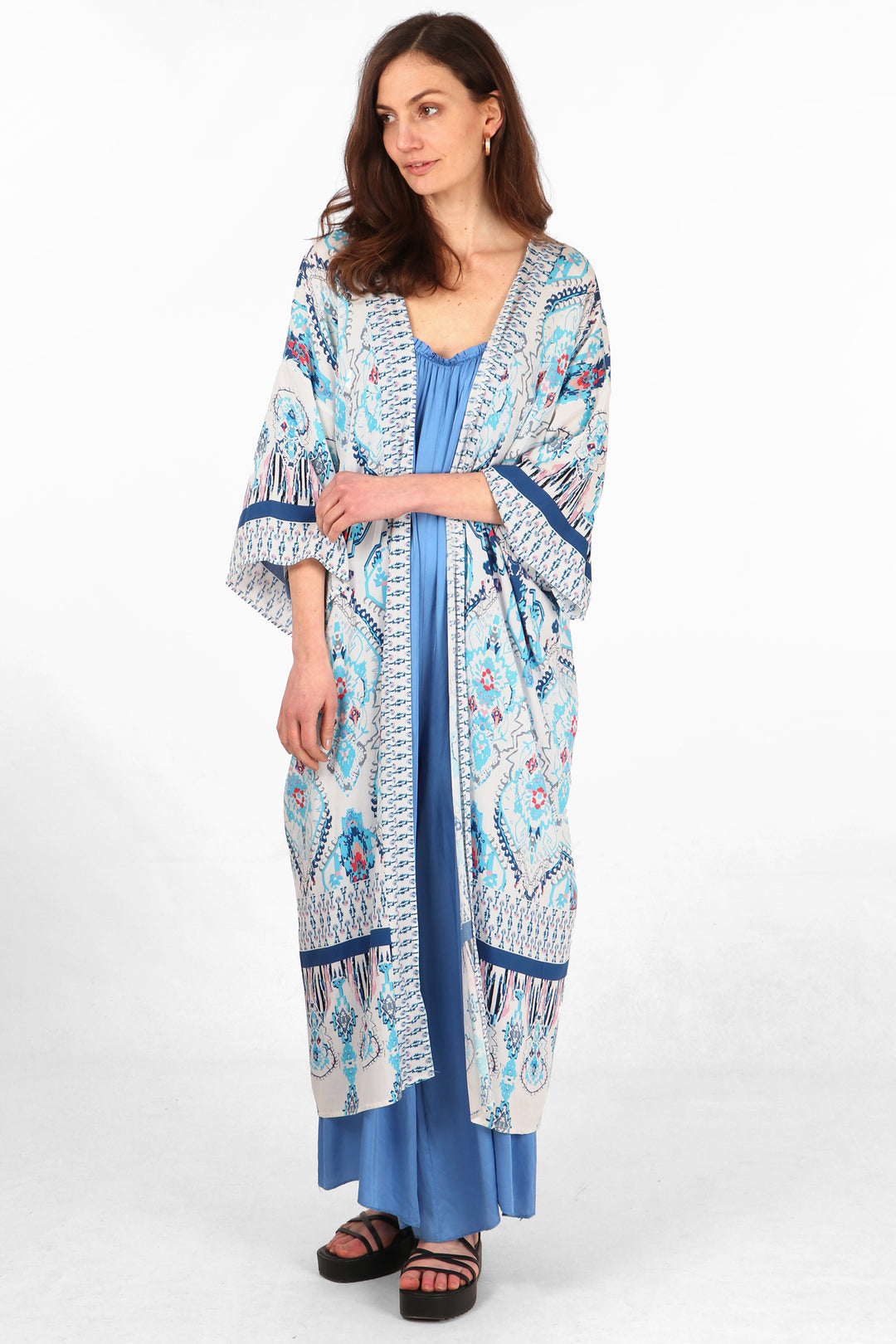 model wearing a midi length open front kimono robe with an ornate blue mandala print pattern and 3/4 sleeves