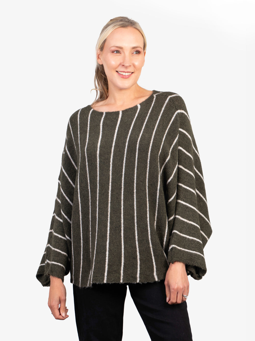 model wearing an oversized khaki green knitted jumper with vertical cream stripes and a boat neck