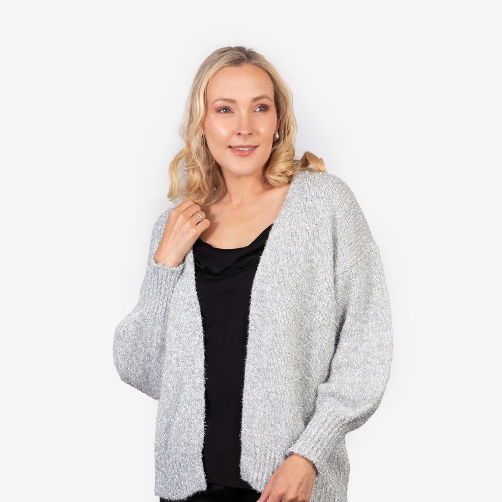 model wearing a gold sparkly tinsel effect knitted cardigan in silver