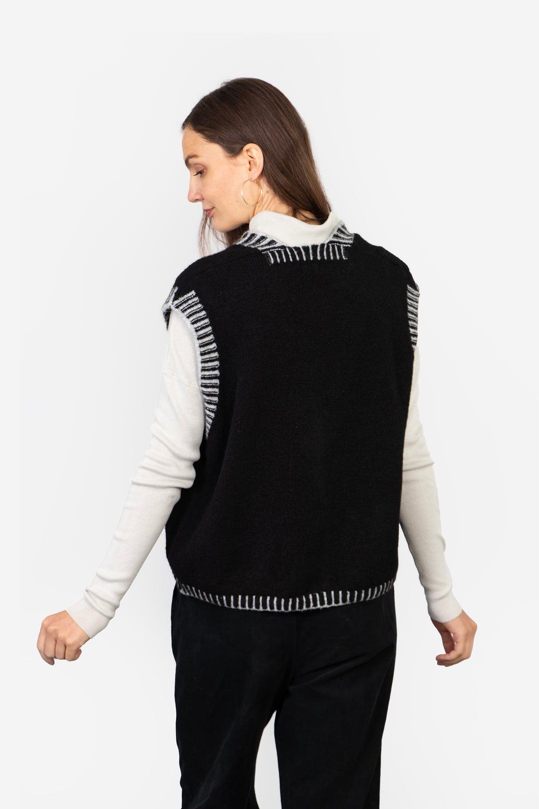 model showing the back of the vest, the striped ribbed trims go all around the piece