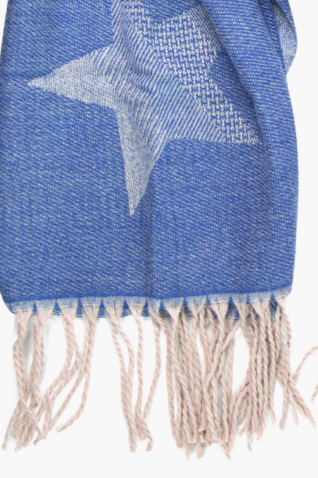 close up of the blue ombre star patten and tasselled edge