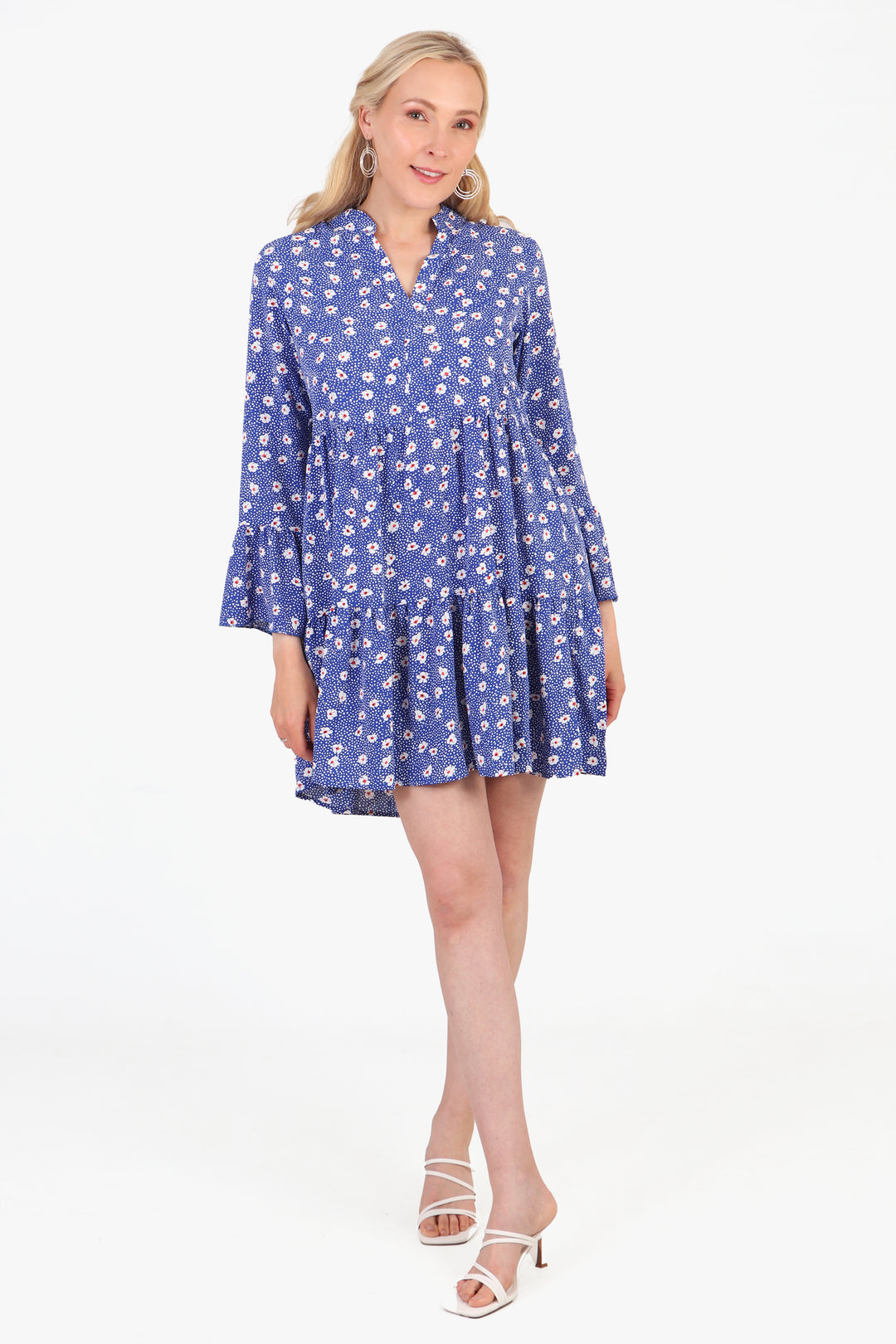 model wearing a short blue floral pattern mini dress with 3/4 length fluted sleeves