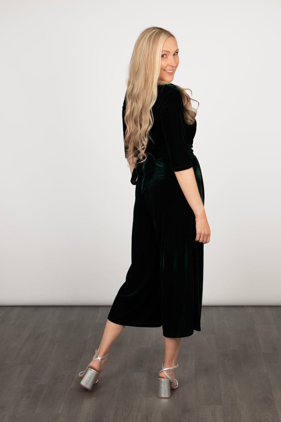 model showing the back of the jumpsuit, showing the waist tie feature