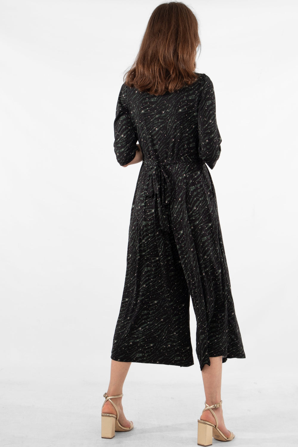 model showing the back of the jumpsuit and waist tie