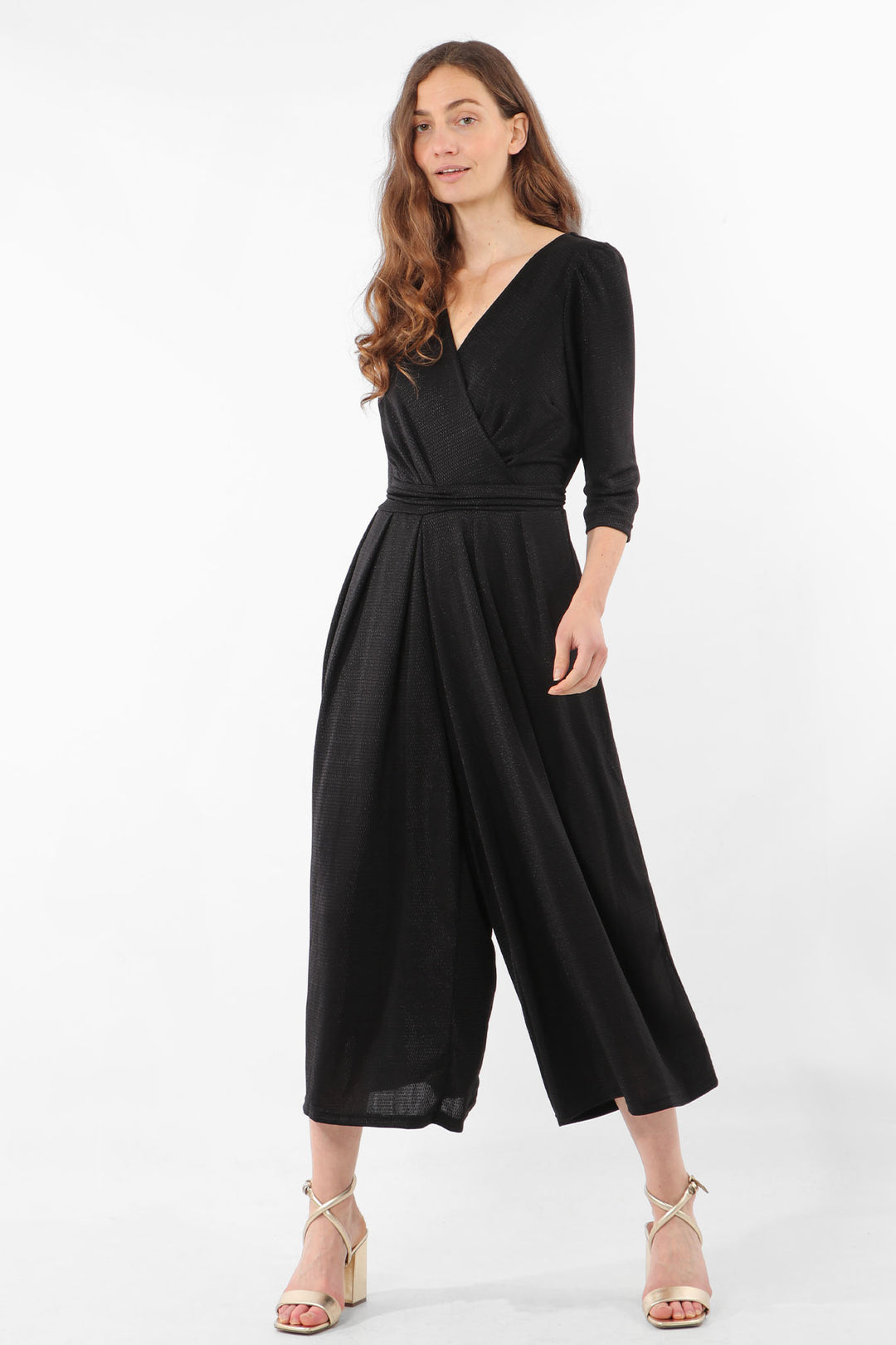 model wearing a black glitter cropped wide leg jumpsuit