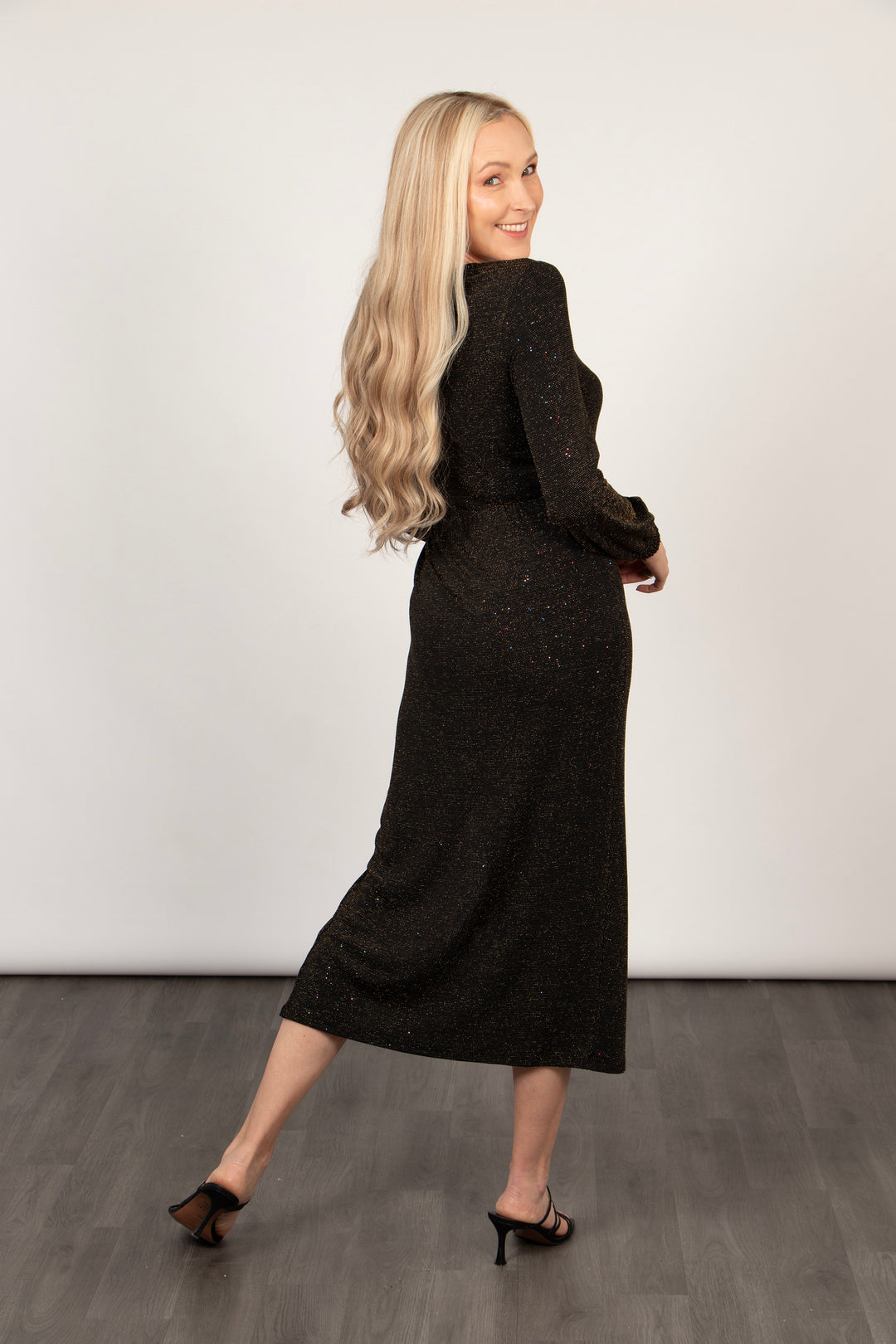 showing the back of the dress, this piece has long sleeves and an all over bronze glitter sparkle