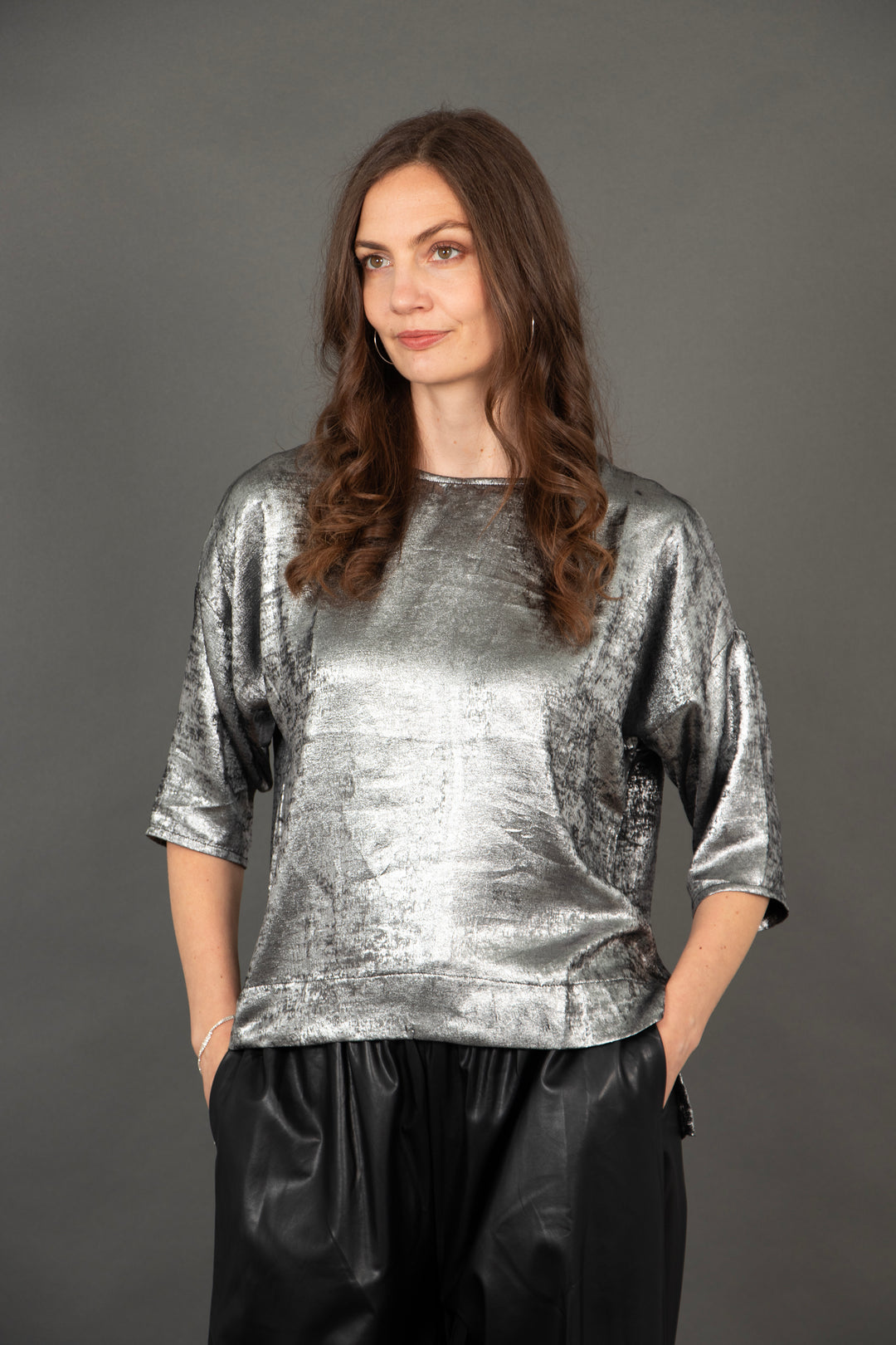 model wearing a silver relaxed fitting 3/4 sleeve top