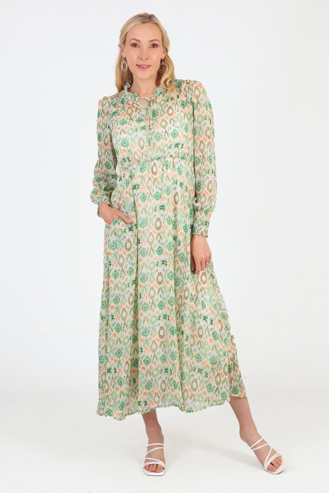 model wearing a long sleeve green dress with an ikat pattern, grandad collar and front tie