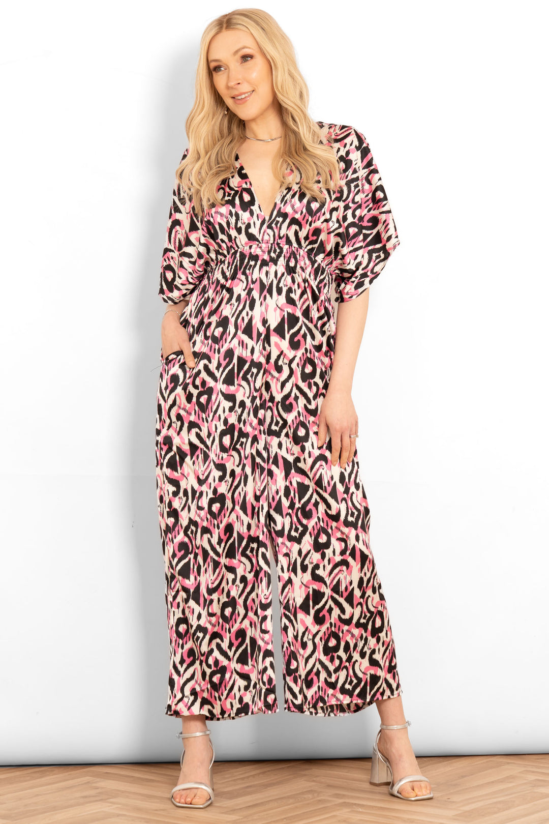 jilly-deep-v-jumpsuit-pink-abstract-ikat-model-front-view-side-pockets