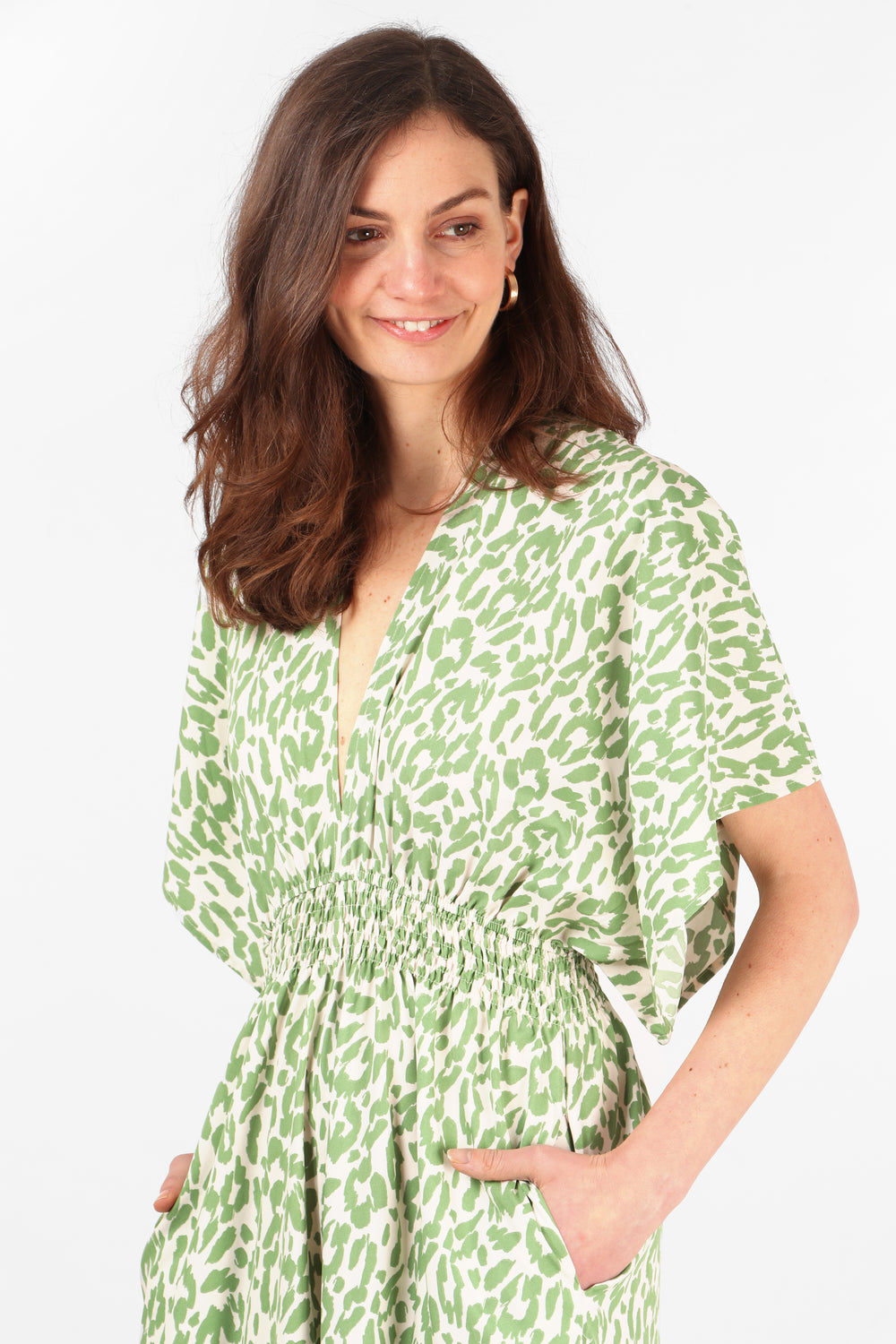close up of  the shirred waist and pockets on the green leopard print jumpsuit