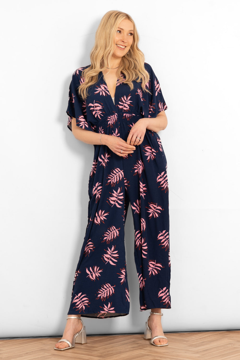 jilly-deep-v-jumpsuit-navy-blue-pink-palm-leaf-model-front-view