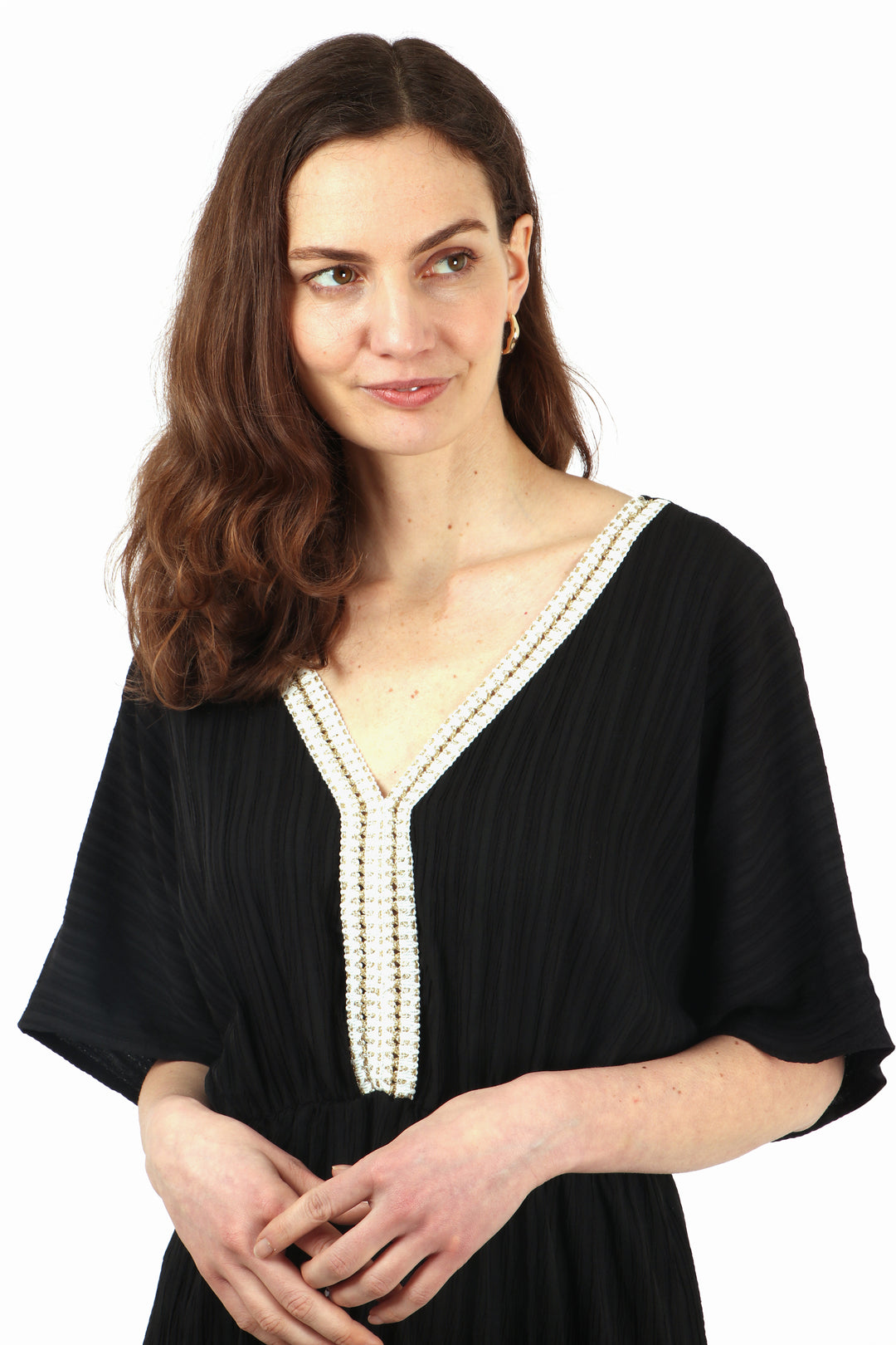 close up of the gold rope trim detail at the neckline, the dress has a v neck