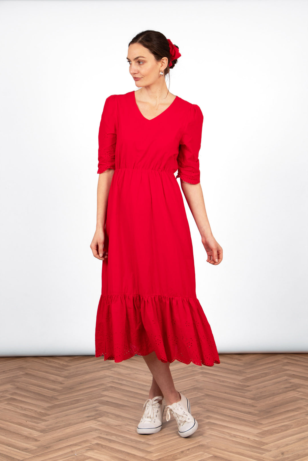 aurelia-cotton-fit-flare-midaxi-dress-red-broderie-anglaise-styled-on-model-front-view-white-trainers-red-scrunchie