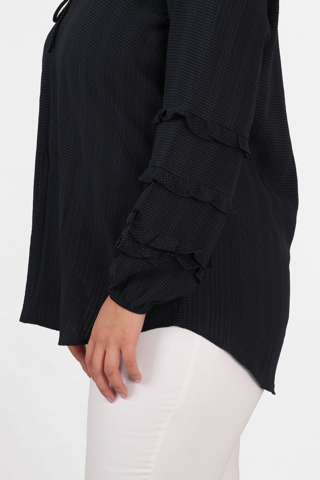 a close up of the frills on the sleeves of the blouse
