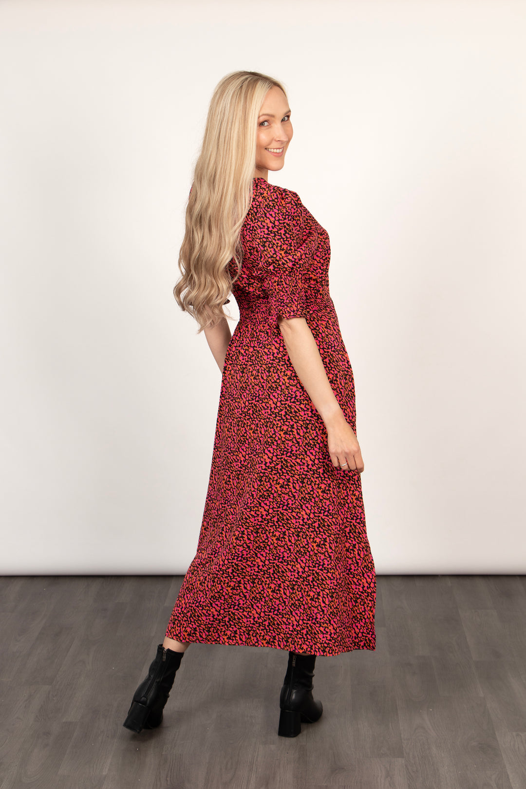 model showing the back of the tea dress, the hem falls mid calf