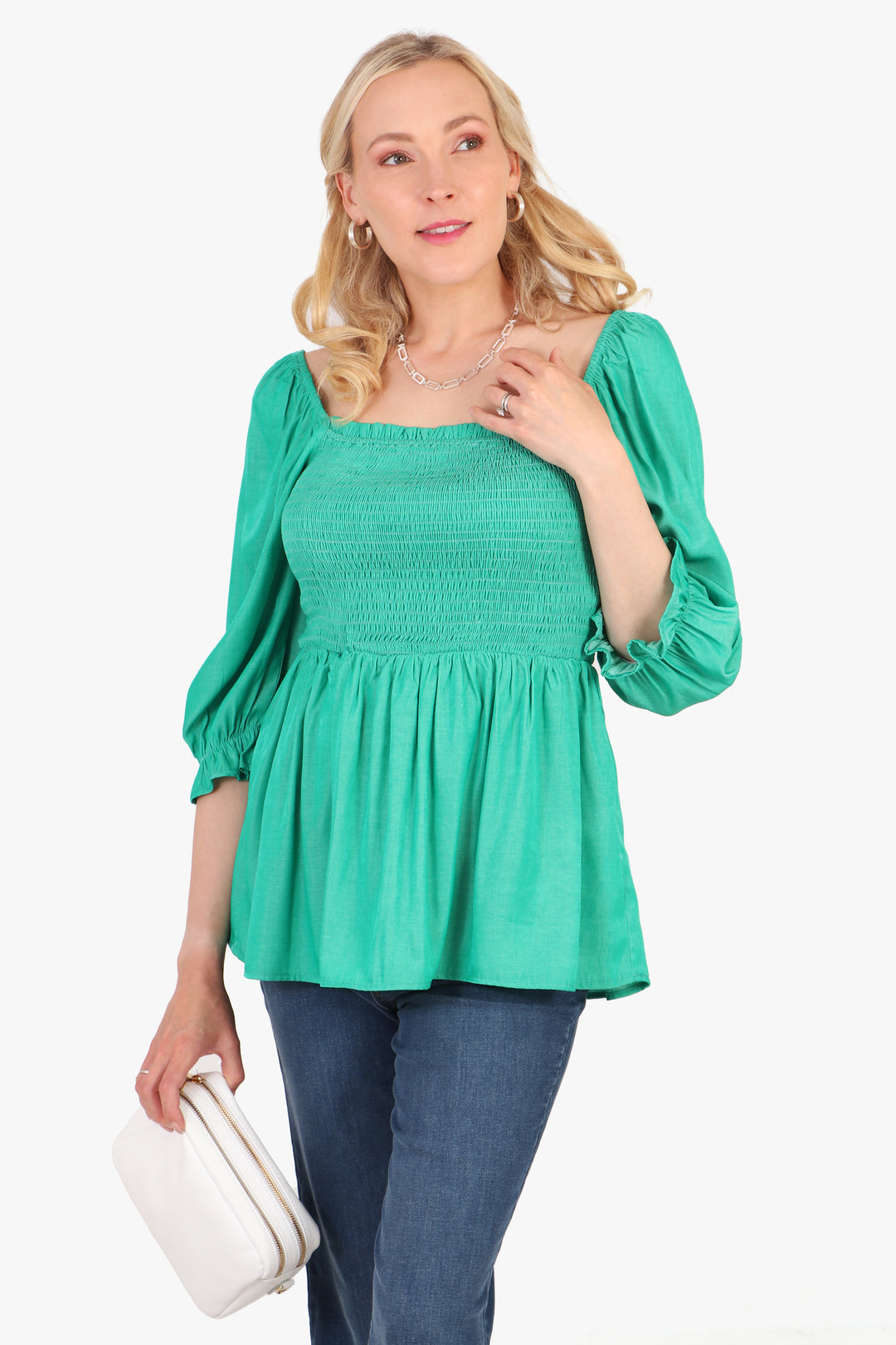 model wearing a plain green shirred bodice milkmaid top