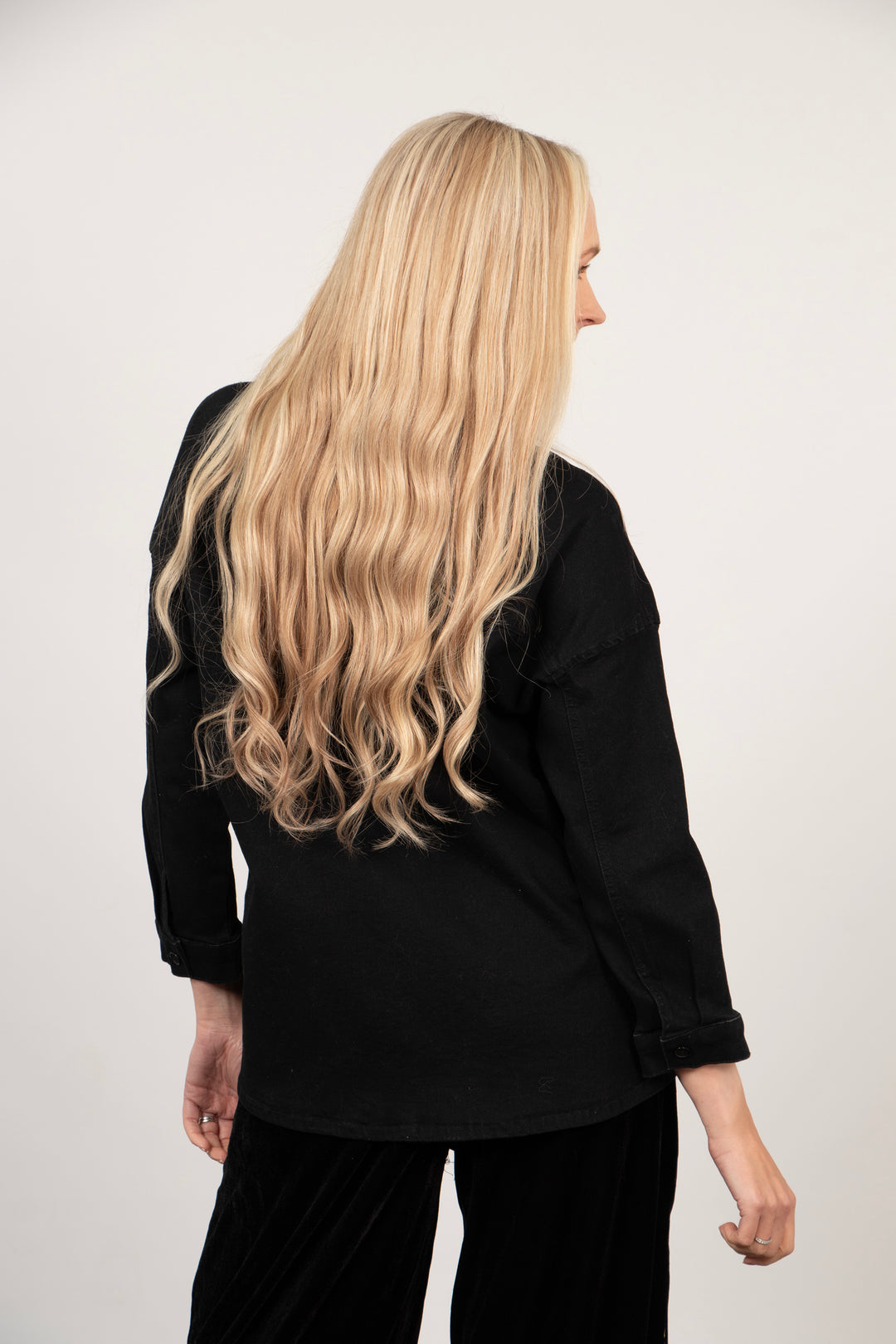 model showing the back of the shacket, highlighting the length of the hem which falls below the hips