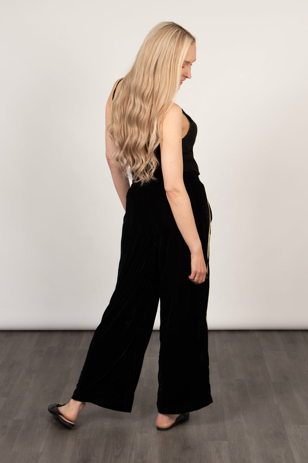 model showing the back of the trousers, highlighting the wide leg design of the piece