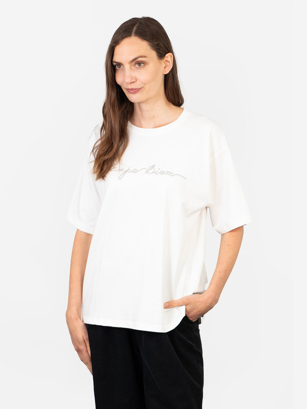 model wearing a white cotton t-shirt with the words, carpe diem, embroidered in silver on the front