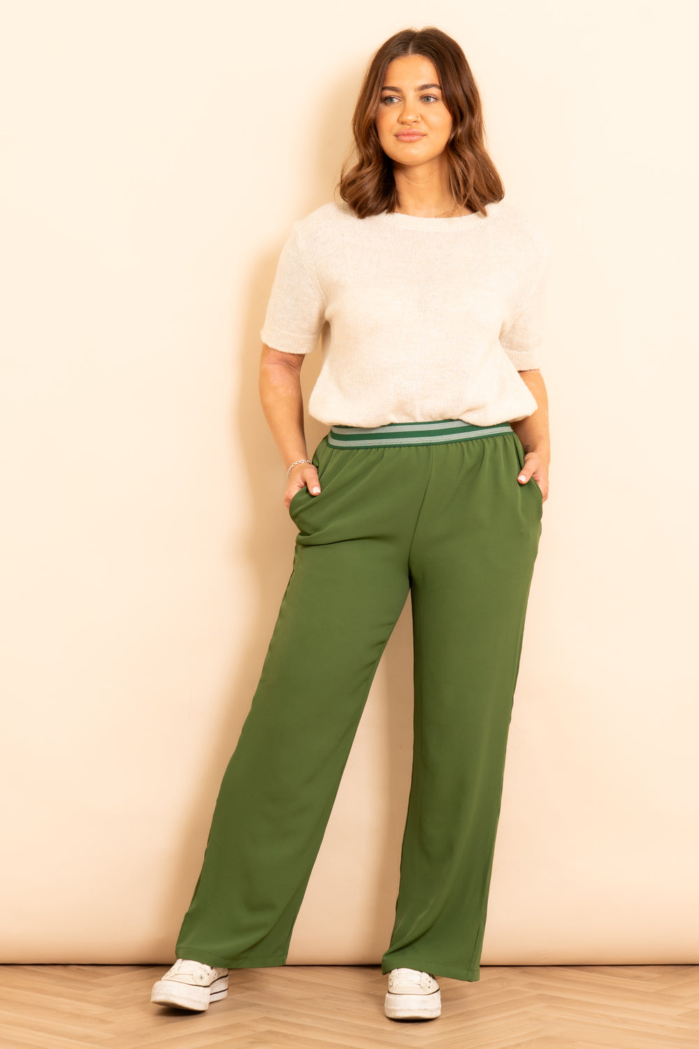 amber-wide-leg-trousers-khaki-striped-waistband-model-showing-pockets
