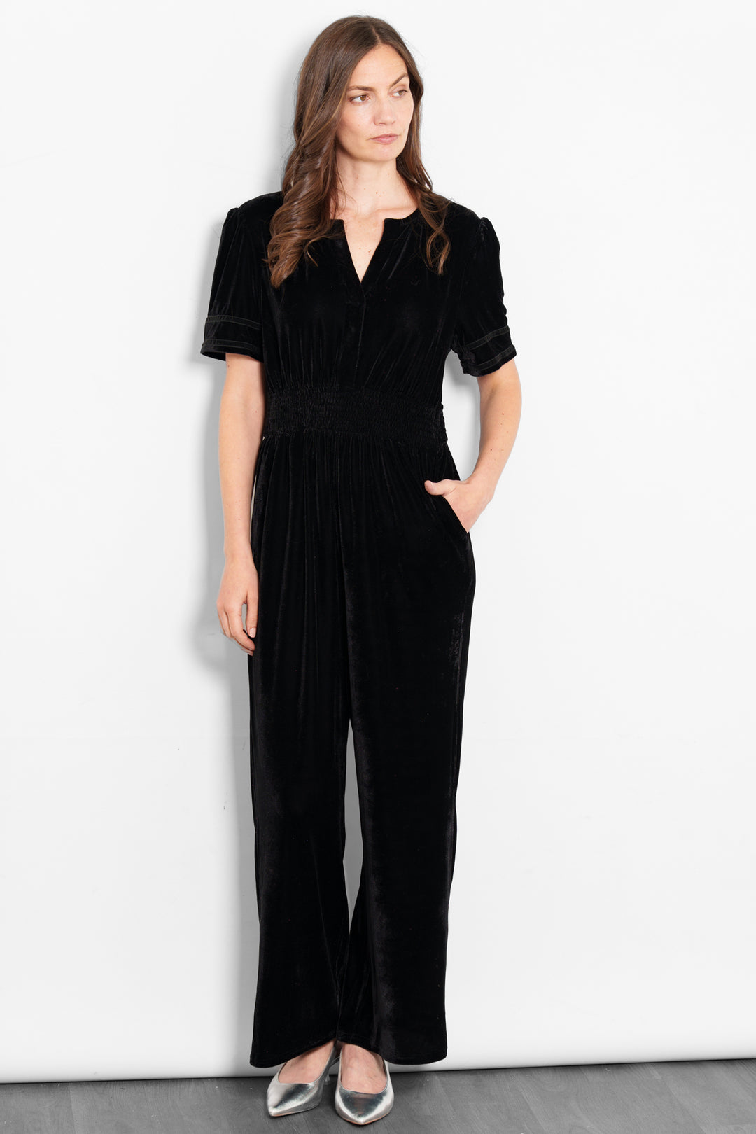 lydia-v-neck-jumpsuit-black-velvet-model-front-view-pockets