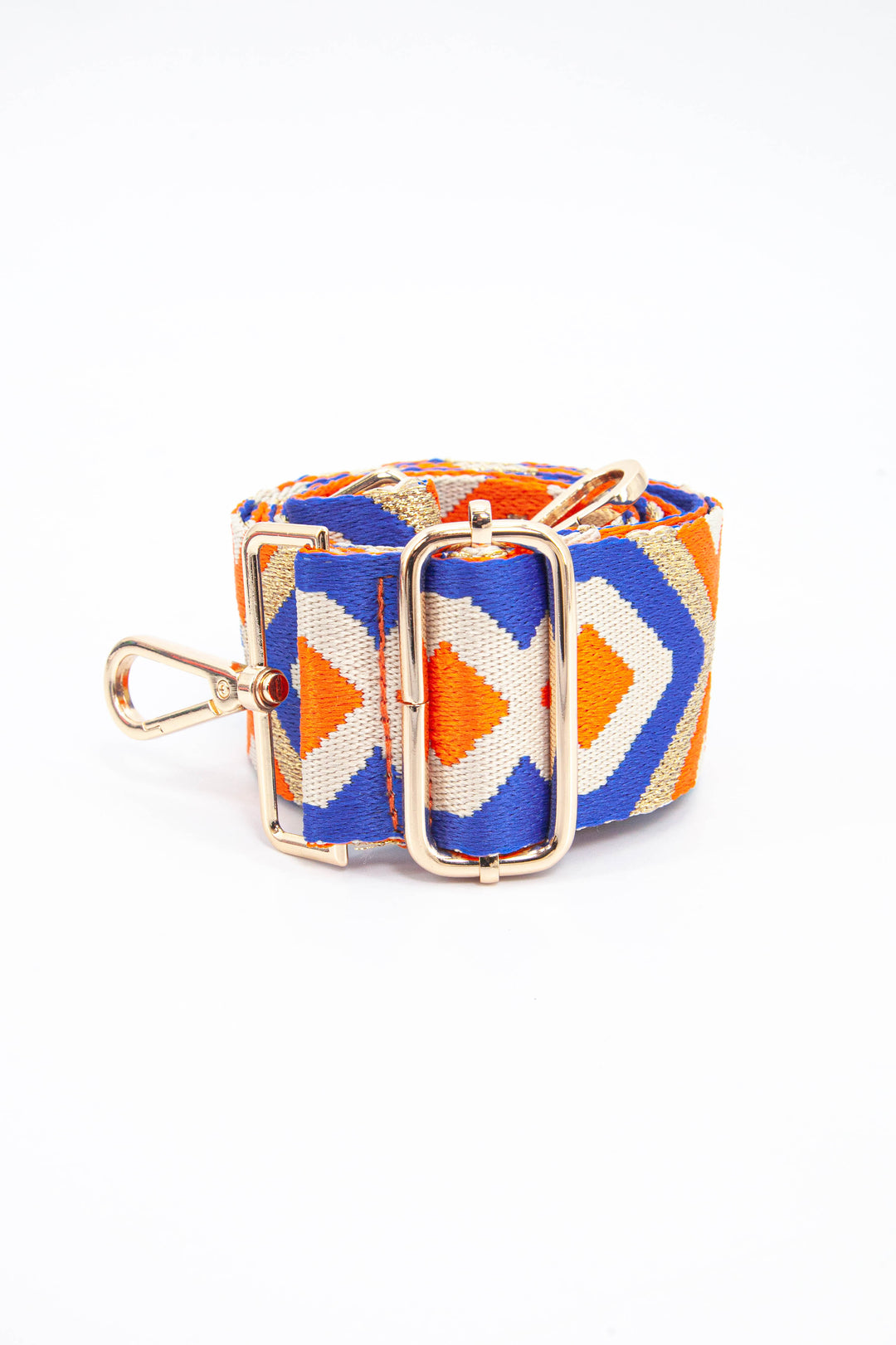 close up of the gold adjustment buckle on the gold, blue and orange aztec pattern bag strap