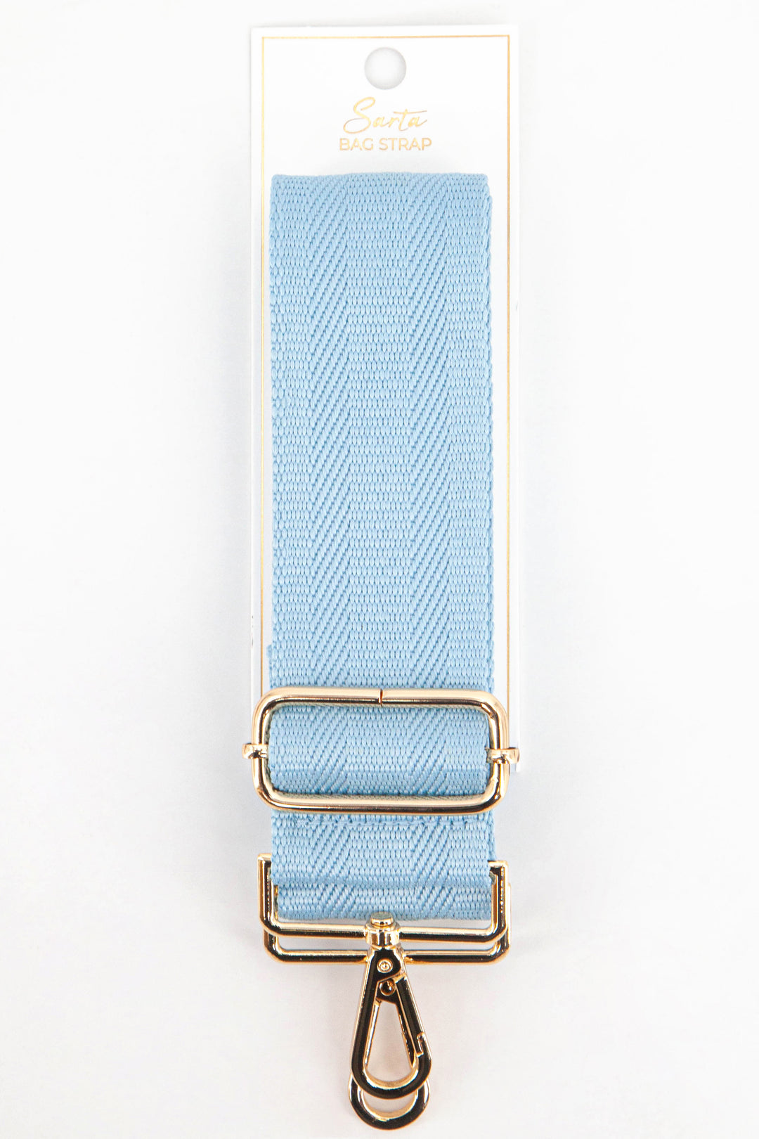 light blue woven bag strap in its sarta packaging.