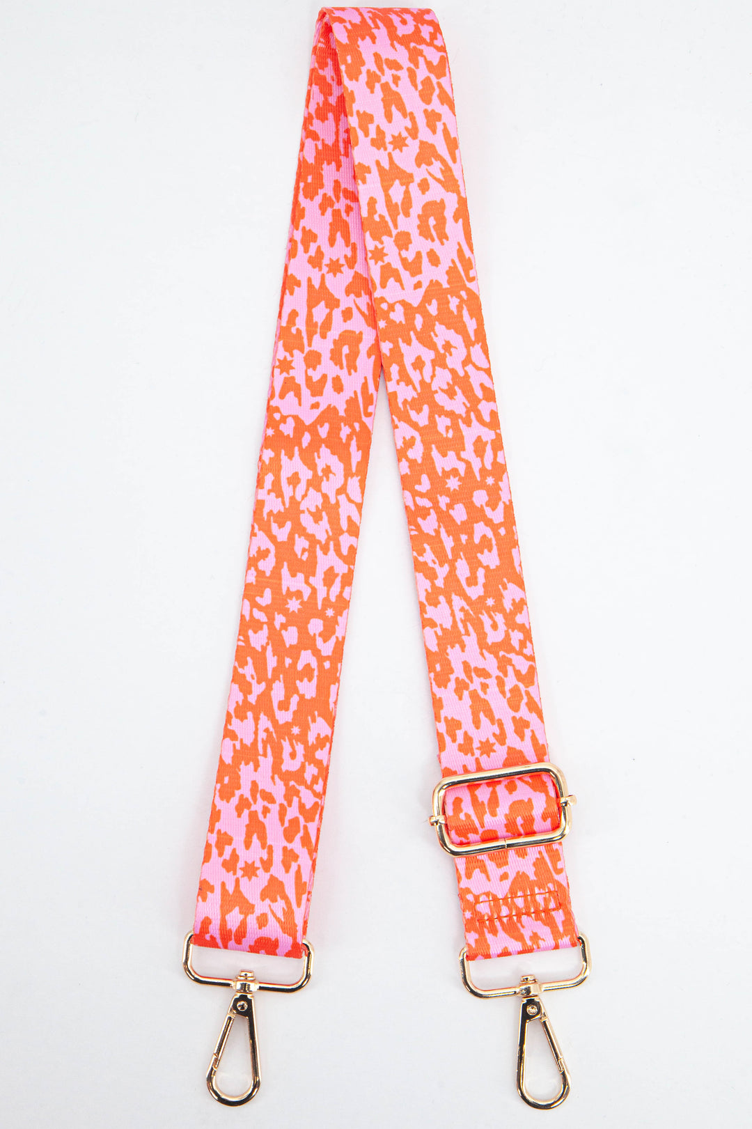 pink and orange animal print bag strap with small stars and gold clip on hardware